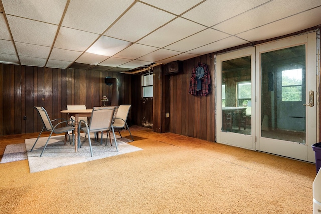 6650 Happy Acres Rd, Rockford, IL 61101 - carpeted dining area with a paneled ceiling and wooden walls