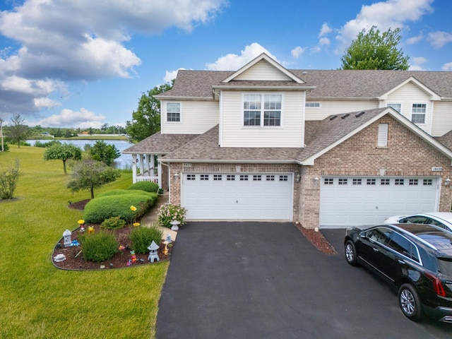 18422 Century Ct, Tinley Park, IL 60477 - traditional home with asphalt driveway, brick siding, a front yard, a water view, and roof with shingles