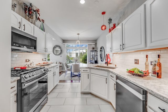 18422 Century Ct, Tinley Park, IL 60477 - kitchen with appliances with stainless steel finishes, white cabinets, decorative backsplash, light stone countertops, and hanging light fixtures