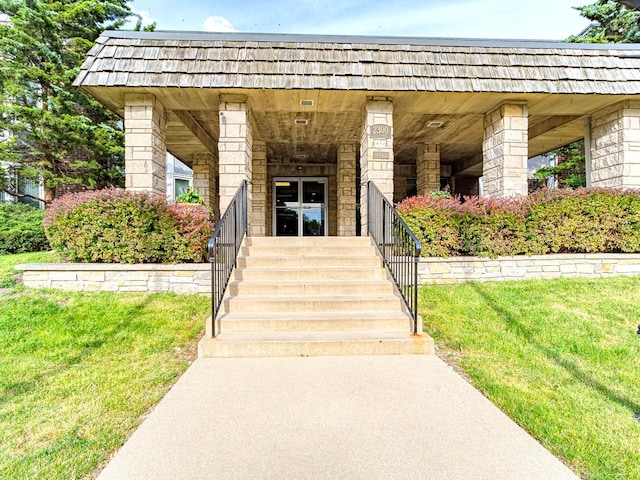2300 Windsor Mall Unit 2G, Park Ridge, IL 60068 - property entrance with mansard roof, a yard, and covered porch