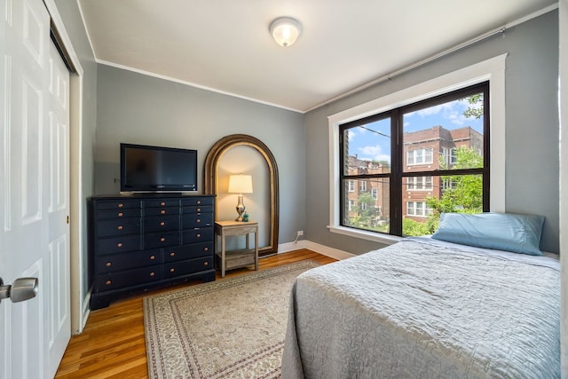 4753 N Talman St Unit 2S, Chicago, IL 60625 - bedroom featuring wood finished floors, ornamental molding, and a closet