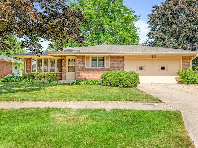 409 Lynne Ln, Belvidere, IL 61008 - single story home featuring brick siding, concrete driveway, a front lawn, and a garage