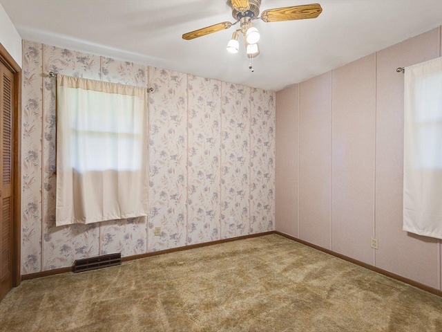 409 Lynne Ln, Belvidere, IL 61008 - empty room featuring carpet flooring, plenty of natural light, and ceiling fan
