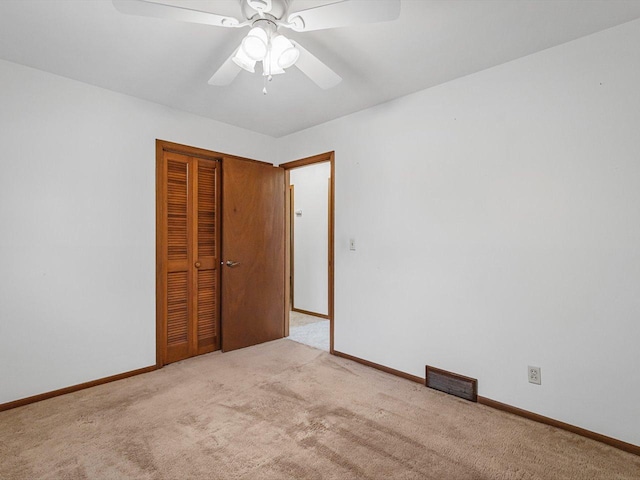 409 Lynne Ln, Belvidere, IL 61008 - unfurnished bedroom featuring carpet floors, a closet, and a ceiling fan