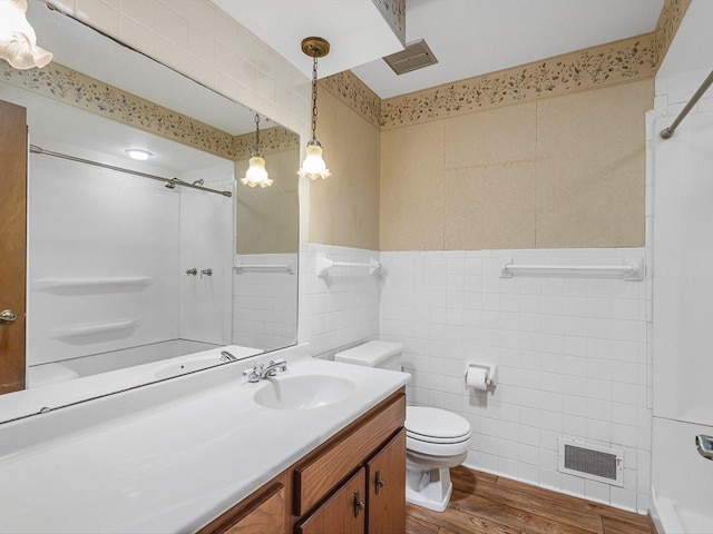 409 Lynne Ln, Belvidere, IL 61008 - bathroom featuring tile walls, wood finished floors, and vanity