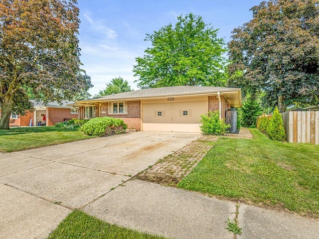 409 Lynne Ln, Belvidere, IL 61008 - ranch-style house featuring an attached garage, brick siding, and driveway