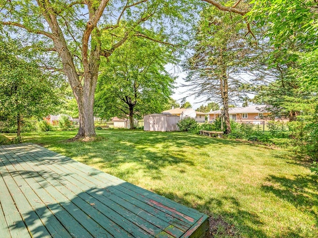 409 Lynne Ln, Belvidere, IL 61008 - view of green lawn featuring a deck and a storage shed