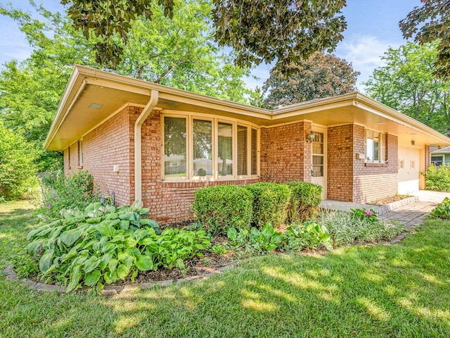 409 Lynne Ln, Belvidere, IL 61008 - view of front of house featuring brick siding and a front yard