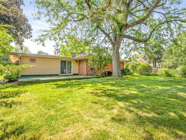 409 Lynne Ln, Belvidere, IL 61008 - rear view of property with a lawn and brick siding