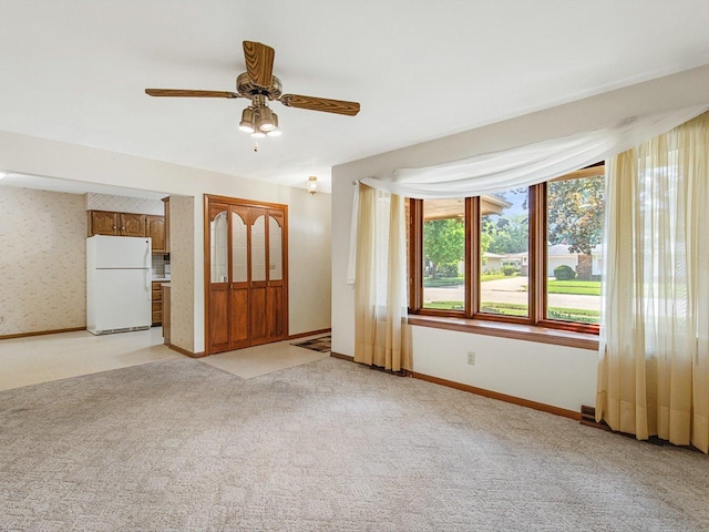 409 Lynne Ln, Belvidere, IL 61008 - unfurnished living room featuring light carpet and a ceiling fan
