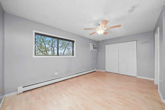 9960 Franchesca Ct Unit 3A, Orland Park, IL 60462 - unfurnished bedroom with a baseboard radiator, light wood-style floors, a wall mounted air conditioner, a closet, and a ceiling fan