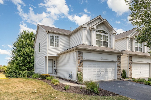1617 Fieldstone Dr S Unit 13-1, Shorewood, IL 60404 - traditional-style home featuring an attached garage, asphalt driveway, stone siding, and a front lawn