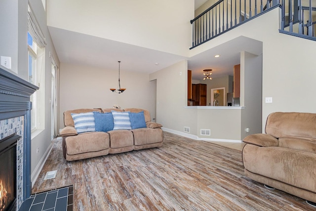1617 Fieldstone Dr S Unit 13-1, Shorewood, IL 60404 - living area with a glass covered fireplace, wood finished floors, and a high ceiling
