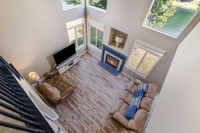 1617 Fieldstone Dr S Unit 13-1, Shorewood, IL 60404 - living room featuring a high ceiling, a glass covered fireplace, and wood finished floors