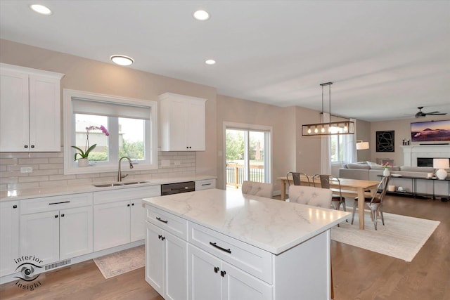 23008 Anna Ln, Frankfort, IL 60423 - kitchen with backsplash, light wood-style flooring, a kitchen island, light stone countertops, and open floor plan