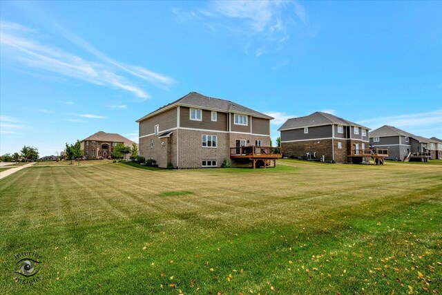 23008 Anna Ln, Frankfort, IL 60423 - back of property featuring a yard, a wooden deck, a residential view, and brick siding