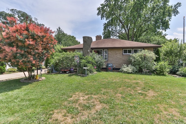 511 Crystal Ave, South Elgin, IL 60177 - view of front of home with a chimney, a front lawn, and brick siding