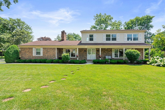 3930 Bordeaux Ct, Northbrook, IL 60062 - traditional home with a chimney, a front yard, and brick siding