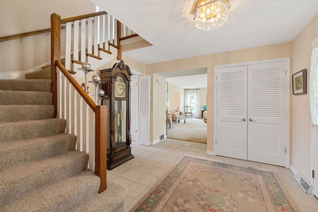 3930 Bordeaux Ct, Northbrook, IL 60062 - entryway with light tile patterned flooring, stairs, and a chandelier