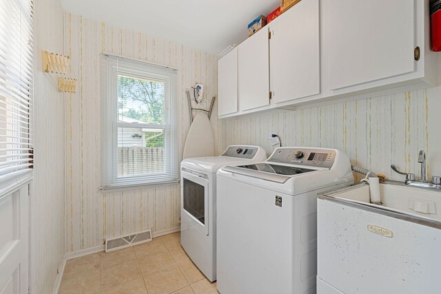 3930 Bordeaux Ct, Northbrook, IL 60062 - laundry room with washer and dryer, wallpapered walls, cabinet space, and light tile patterned floors