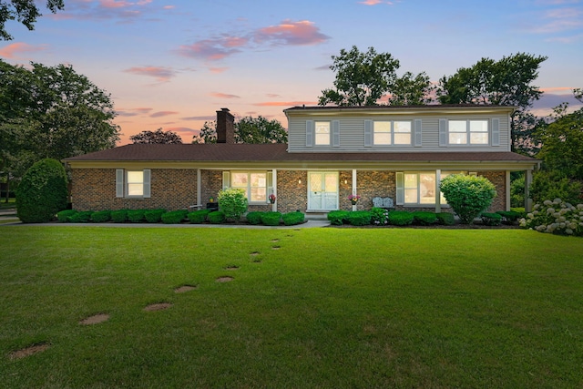 3930 Bordeaux Ct, Northbrook, IL 60062 - traditional-style home featuring a yard, a chimney, covered porch, and brick siding