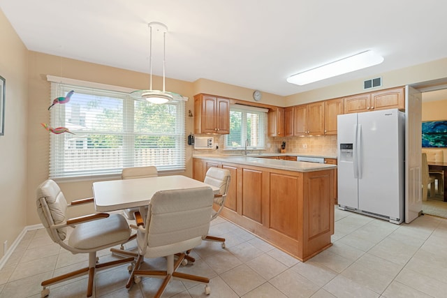 3930 Bordeaux Ct, Northbrook, IL 60062 - kitchen with white appliances, light countertops, a peninsula, tasteful backsplash, and light tile patterned flooring