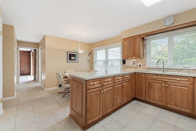 3930 Bordeaux Ct, Northbrook, IL 60062 - kitchen featuring light tile patterned flooring, brown cabinetry, and a peninsula