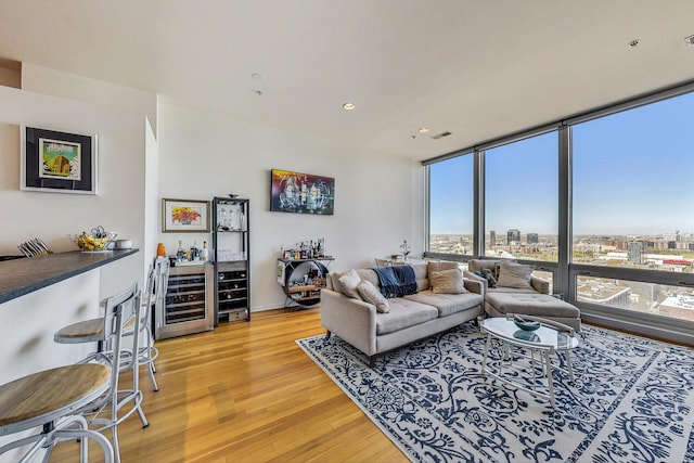 500 W Superior St Unit 1804, Chicago, IL 60654 - living area with beverage cooler, light wood-style flooring, plenty of natural light, a bar, and recessed lighting