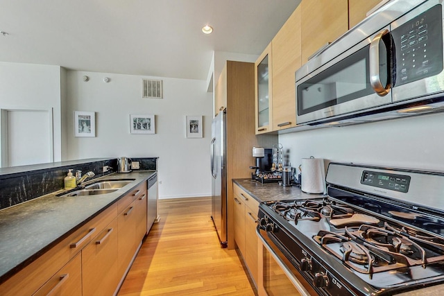 500 W Superior St Unit 1804, Chicago, IL 60654 - kitchen with appliances with stainless steel finishes, light wood-type flooring, glass insert cabinets, and recessed lighting