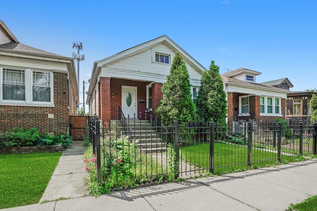 3545 W 62nd Pl, Chicago, IL 60629 - view of front facade featuring a gate, brick siding, and a fenced front yard