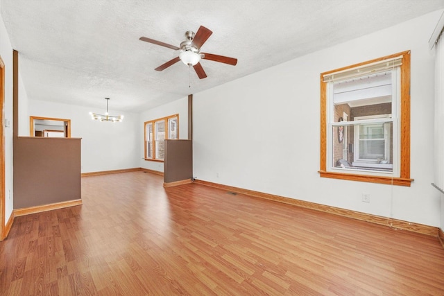3545 W 62nd Pl, Chicago, IL 60629 - unfurnished room featuring a chandelier, light wood-type flooring, a textured ceiling, and ceiling fan