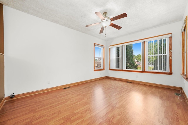3545 W 62nd Pl, Chicago, IL 60629 - empty room with light wood finished floors, ceiling fan, and a textured ceiling