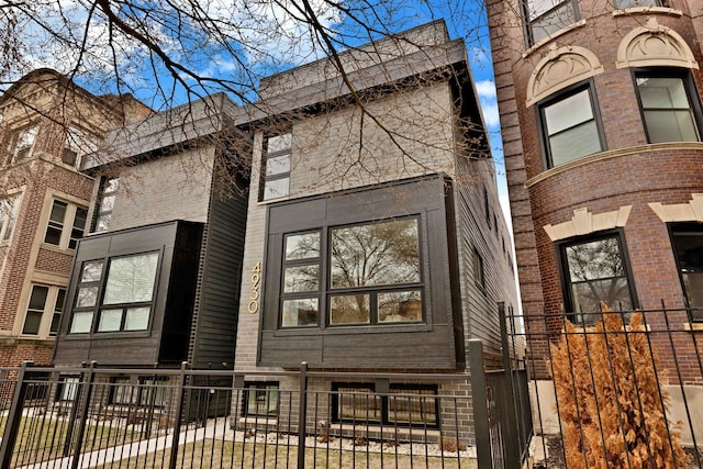 4932 S Martin Luther King Dr, Chicago, IL 60653 - view of side of home featuring a fenced front yard and brick siding
