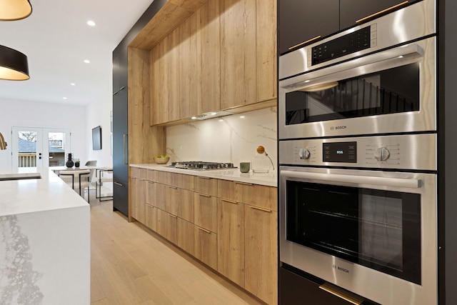 4932 S Martin Luther King Dr, Chicago, IL 60653 - kitchen featuring modern cabinets, stainless steel appliances, light countertops, light wood-style floors, and recessed lighting