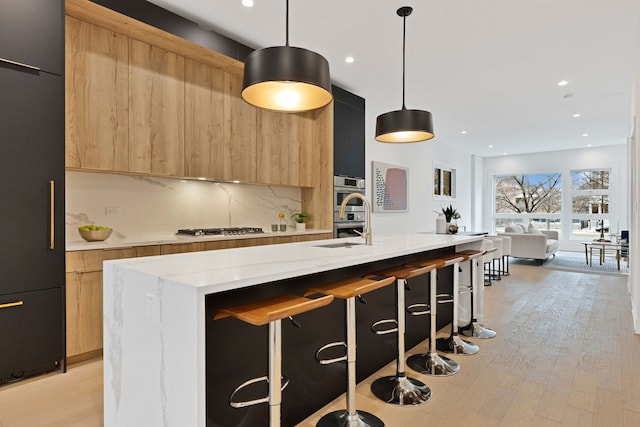 4932 S Martin Luther King Dr, Chicago, IL 60653 - kitchen with modern cabinets, appliances with stainless steel finishes, a center island with sink, backsplash, and recessed lighting