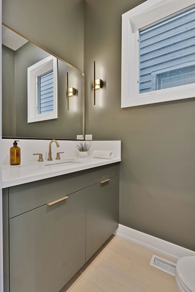 4932 S Martin Luther King Dr, Chicago, IL 60653 - bathroom featuring vanity and wood finished floors