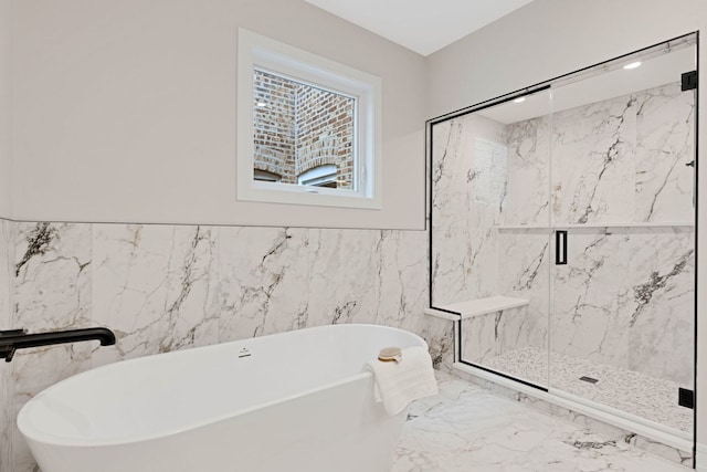 4932 S Martin Luther King Dr, Chicago, IL 60653 - bathroom featuring marble tiled floors, a freestanding tub, a marble finish shower, and tile walls