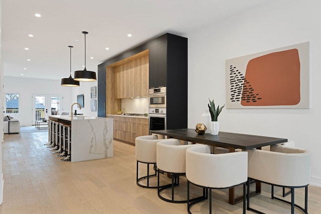 4932 S Martin Luther King Dr, Chicago, IL 60653 - kitchen featuring modern cabinets, a kitchen island with sink, recessed lighting, light wood-style flooring, and stainless steel appliances