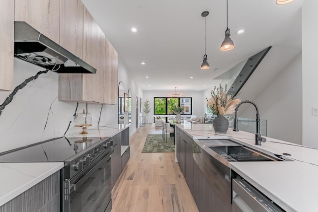 4210 W 5th Ave, Chicago, IL 60624 - kitchen with black electric range, modern cabinets, range hood, light wood-style floors, and light brown cabinetry
