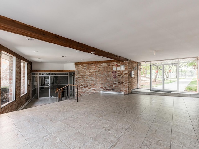 1103 S Hunt Club Dr Unit 125, Mount Prospect, IL 60056 - unfurnished living room with brick wall and beamed ceiling