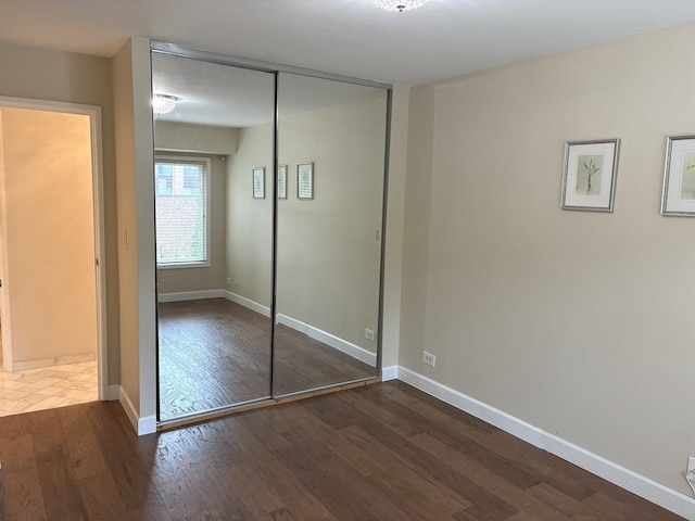1103 S Hunt Club Dr Unit 125, Mount Prospect, IL 60056 - unfurnished bedroom featuring wood finished floors and a closet