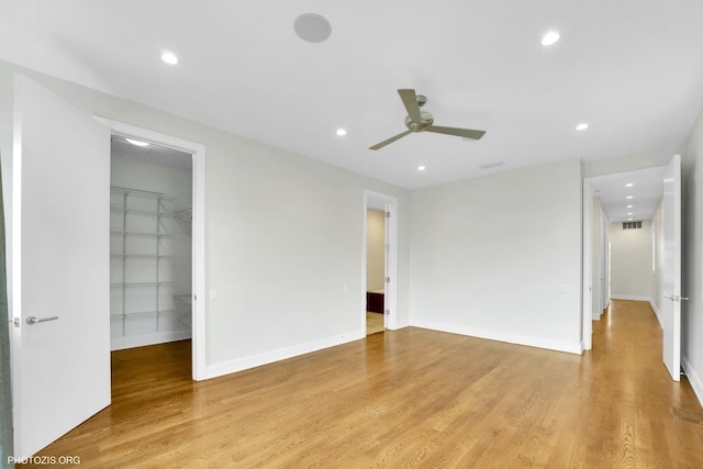 3321 N Sheffield Ave Unit 4, Chicago, IL 60657 - unfurnished bedroom featuring a walk in closet, recessed lighting, light wood-style flooring, a closet, and ceiling fan