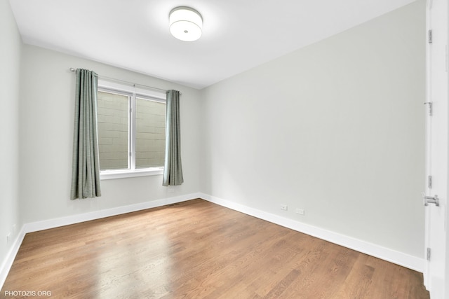 3321 N Sheffield Ave Unit 4, Chicago, IL 60657 - empty room with wood finished floors and baseboards