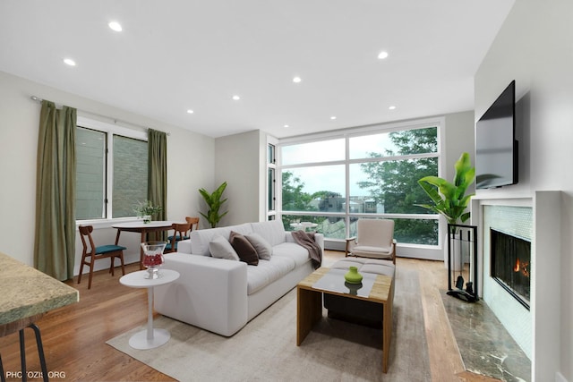 3321 N Sheffield Ave Unit 4, Chicago, IL 60657 - living area with wood finished floors, a warm lit fireplace, recessed lighting, and expansive windows