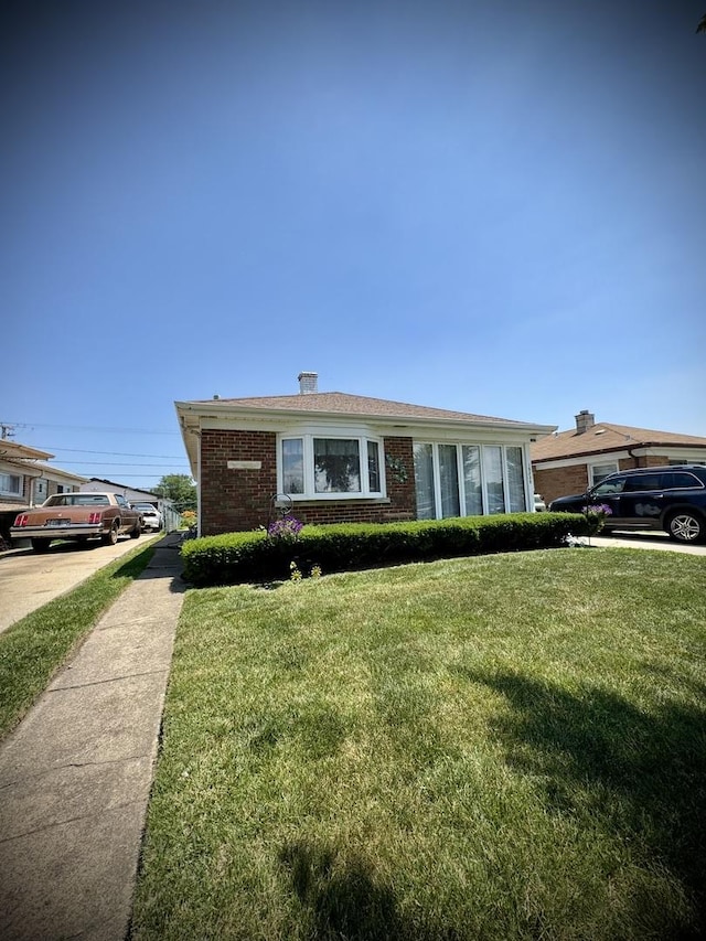 15235 Cottage Grove Ave, Dolton, IL 60419 - ranch-style house featuring a front lawn and brick siding
