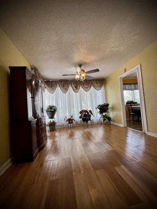 15235 Cottage Grove Ave, Dolton, IL 60419 - living area featuring wood finished floors, a textured ceiling, and a ceiling fan