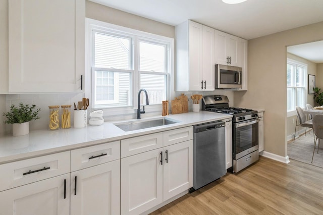 9934 Herrick Ave, Franklin Park, IL 60131 - kitchen with stainless steel appliances, light wood-style floors, white cabinetry, and tasteful backsplash