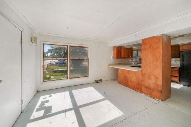 1025 S Ardmore Ave, Villa Park, IL 60181 - kitchen with freestanding refrigerator, brown cabinets, concrete floors, light countertops, and a peninsula