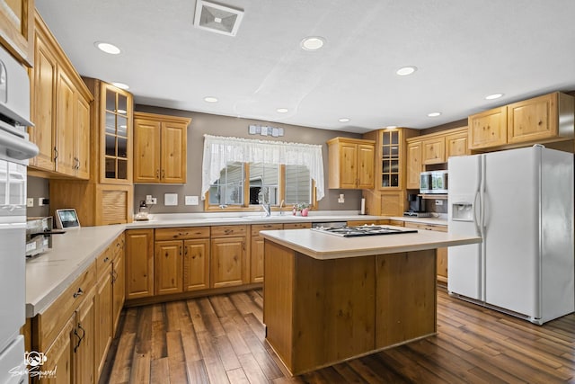 131 E Main St, Essex, IL 60935 - kitchen featuring white fridge with ice dispenser, stainless steel microwave, light countertops, dark wood-type flooring, and recessed lighting