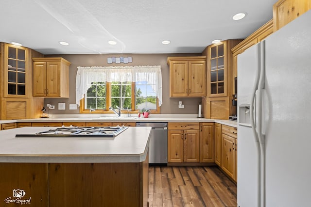 131 E Main St, Essex, IL 60935 - kitchen with white fridge with ice dispenser, stainless steel dishwasher, wood finished floors, light countertops, and recessed lighting